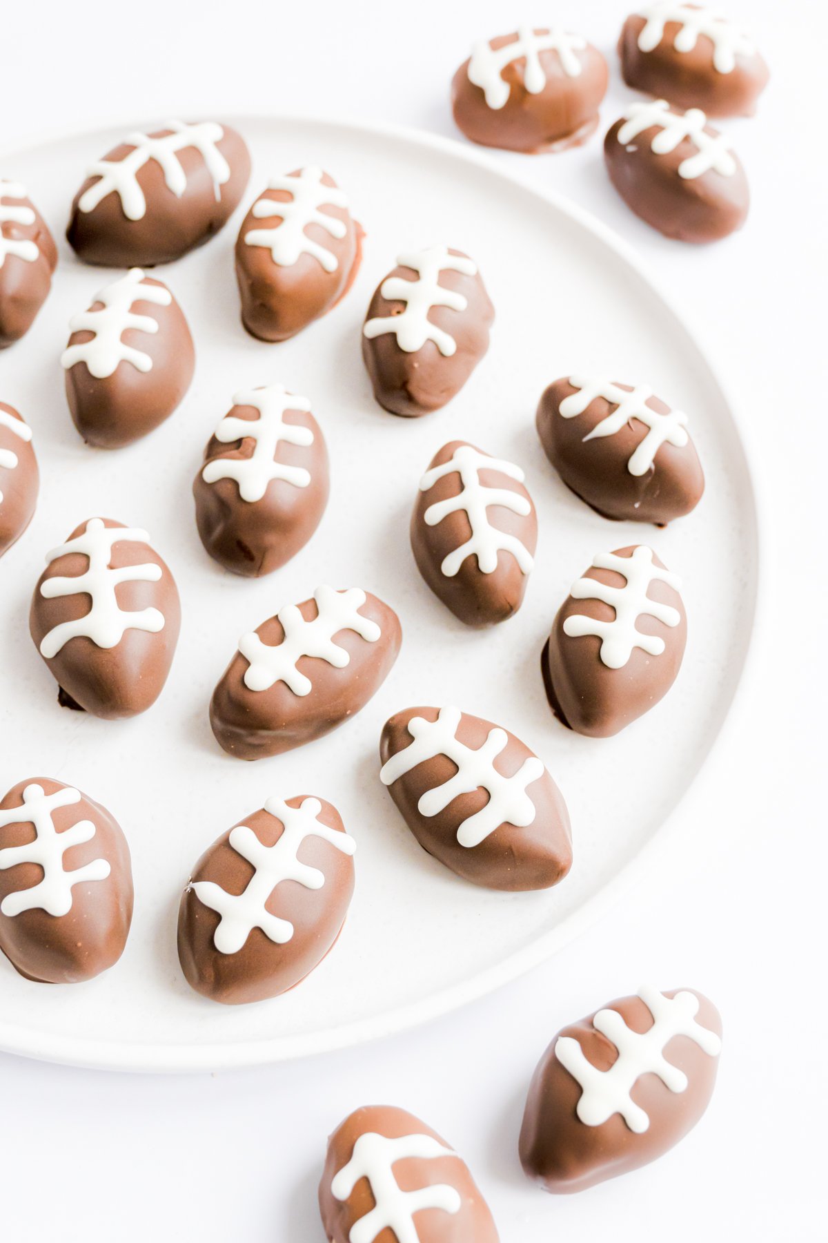 Peanut butter truffles shaped like footballs on a plate.