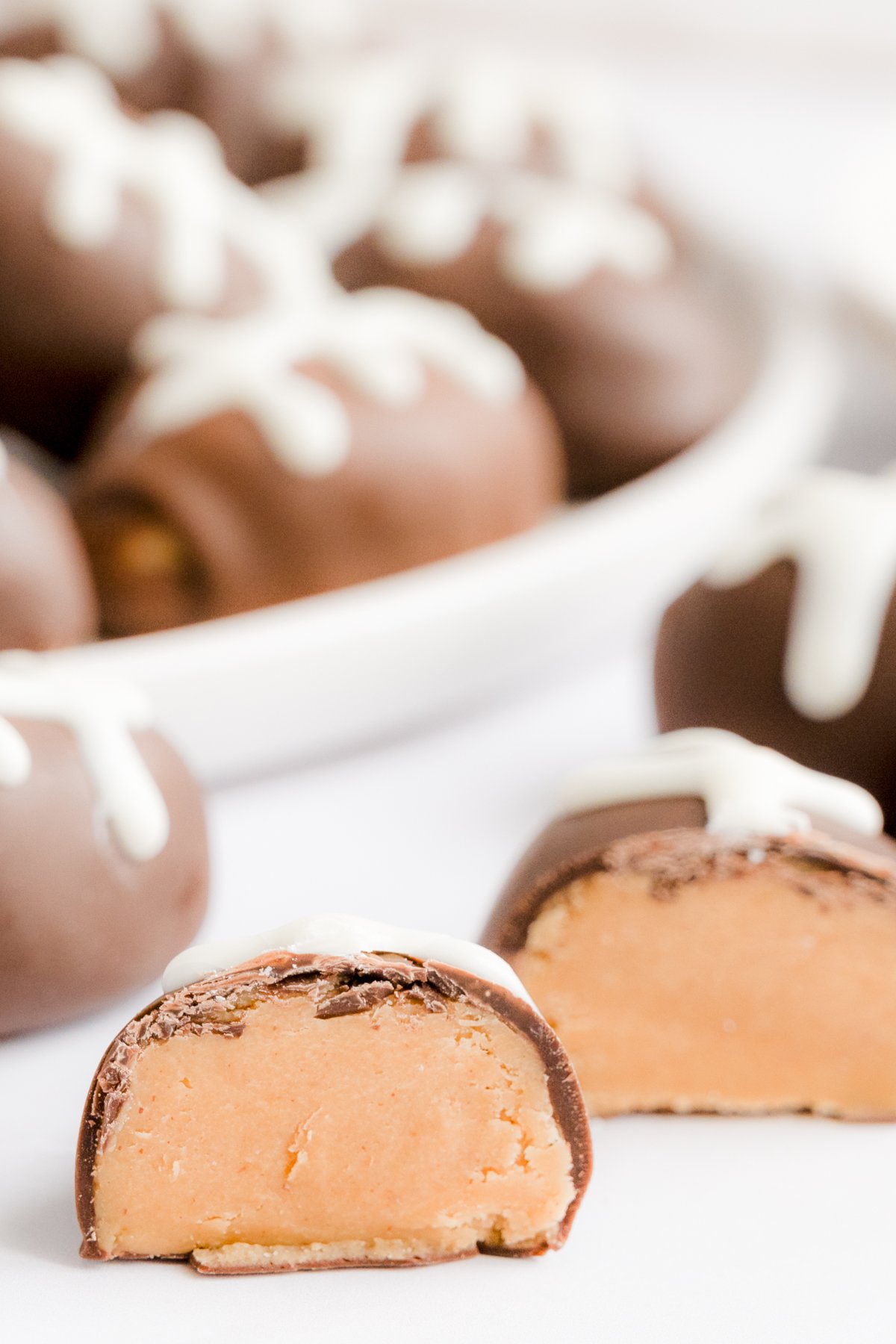 A plate of peanut butter truffles on a white plate.