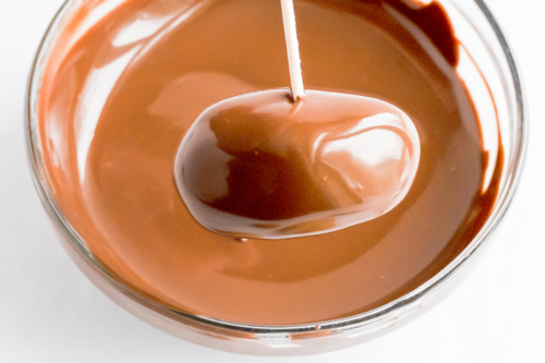 A glass of peanut butter truffles being poured into a glass.