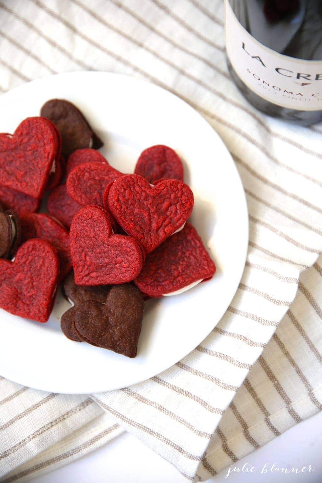 red velvet sandwich cookies on a plate with napkin underneath