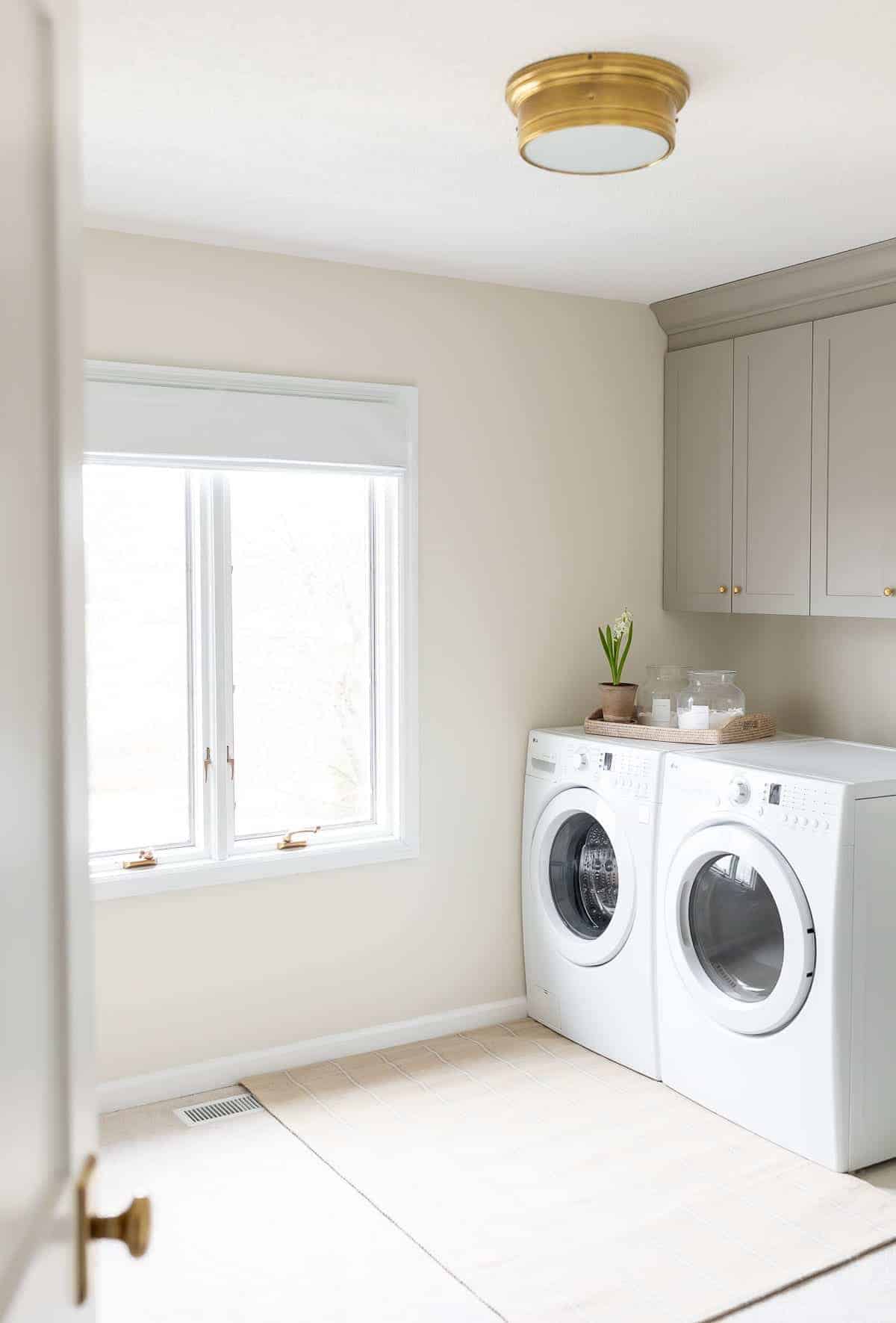 A brass ceiling light in a modern laundry room.