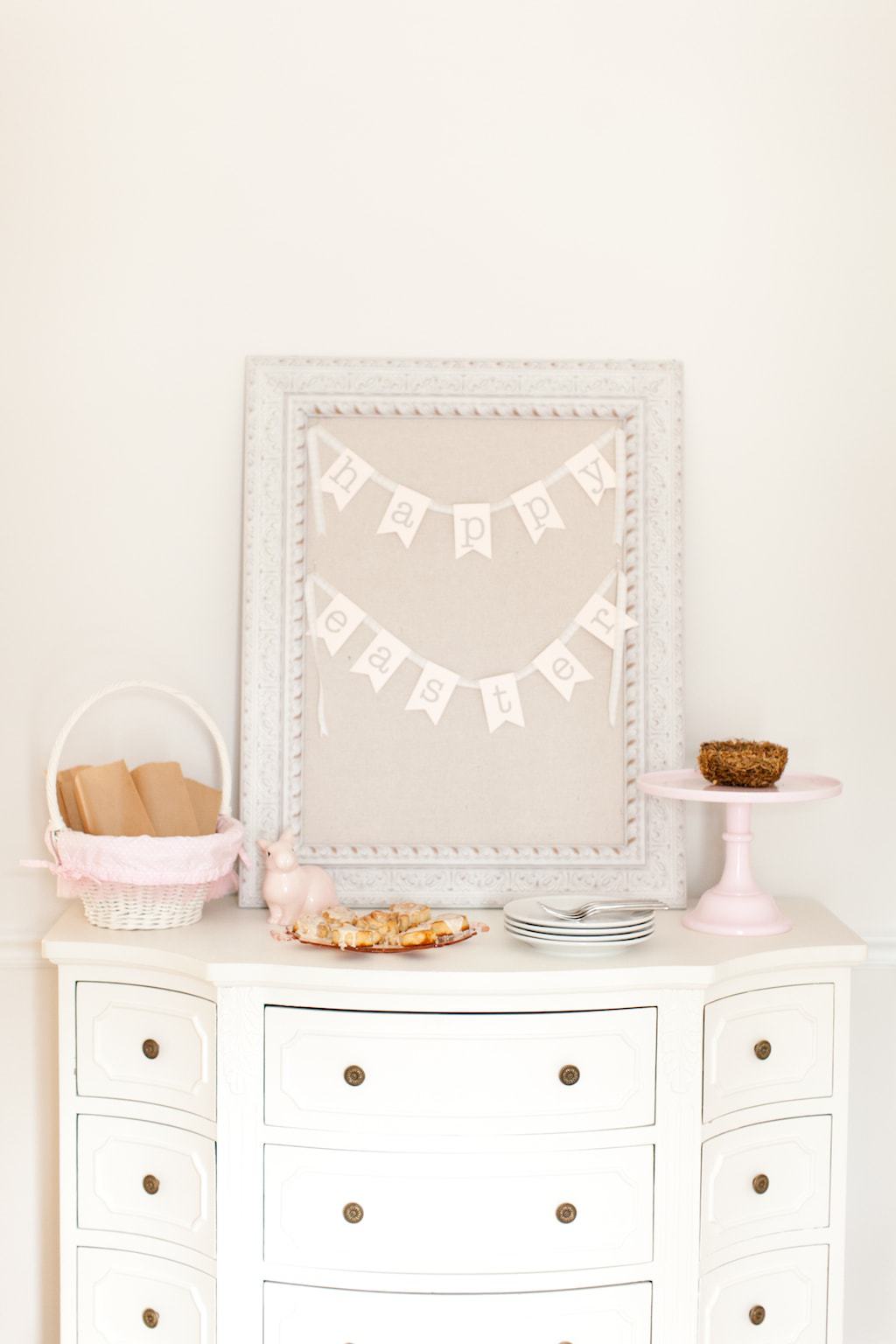 A close up of a dresser with cream walls. 