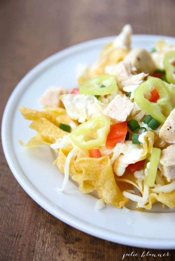 Incredible Italian nachos recipe with asiago cream sauce on a bed of pasta chips!