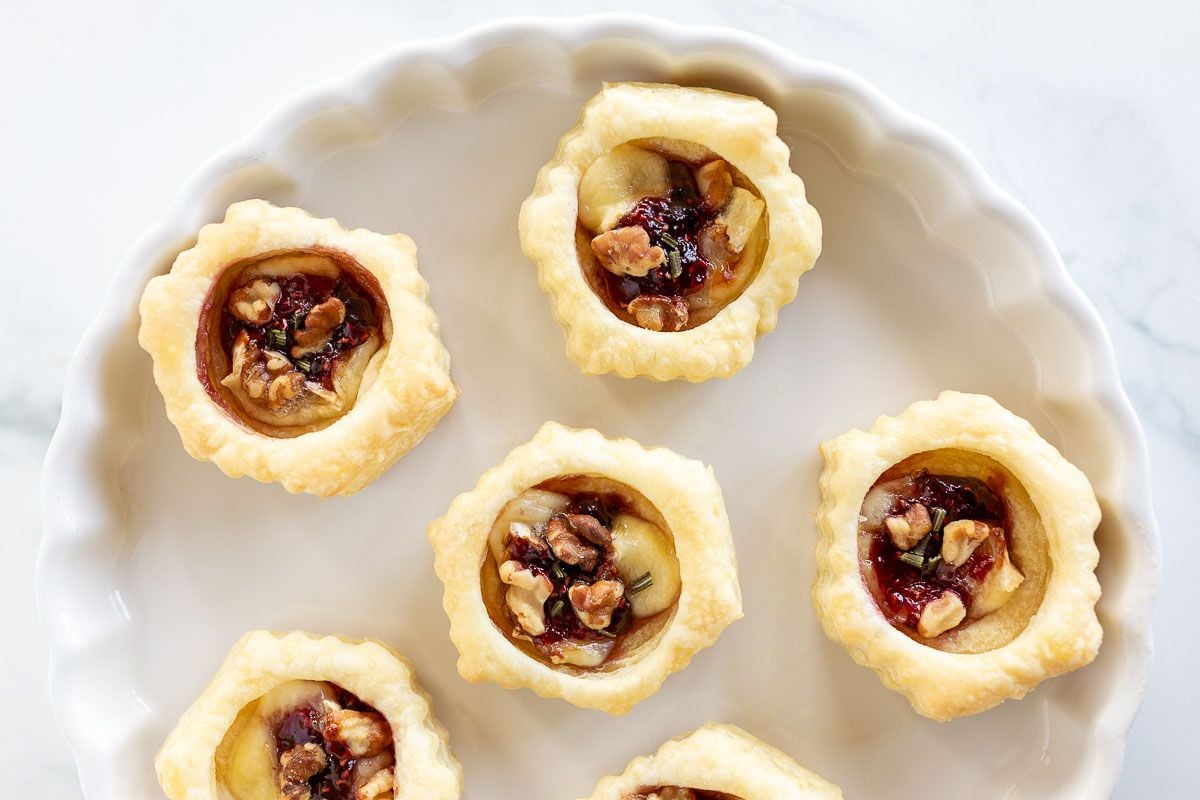 brie bites in puff pastry on a white plate