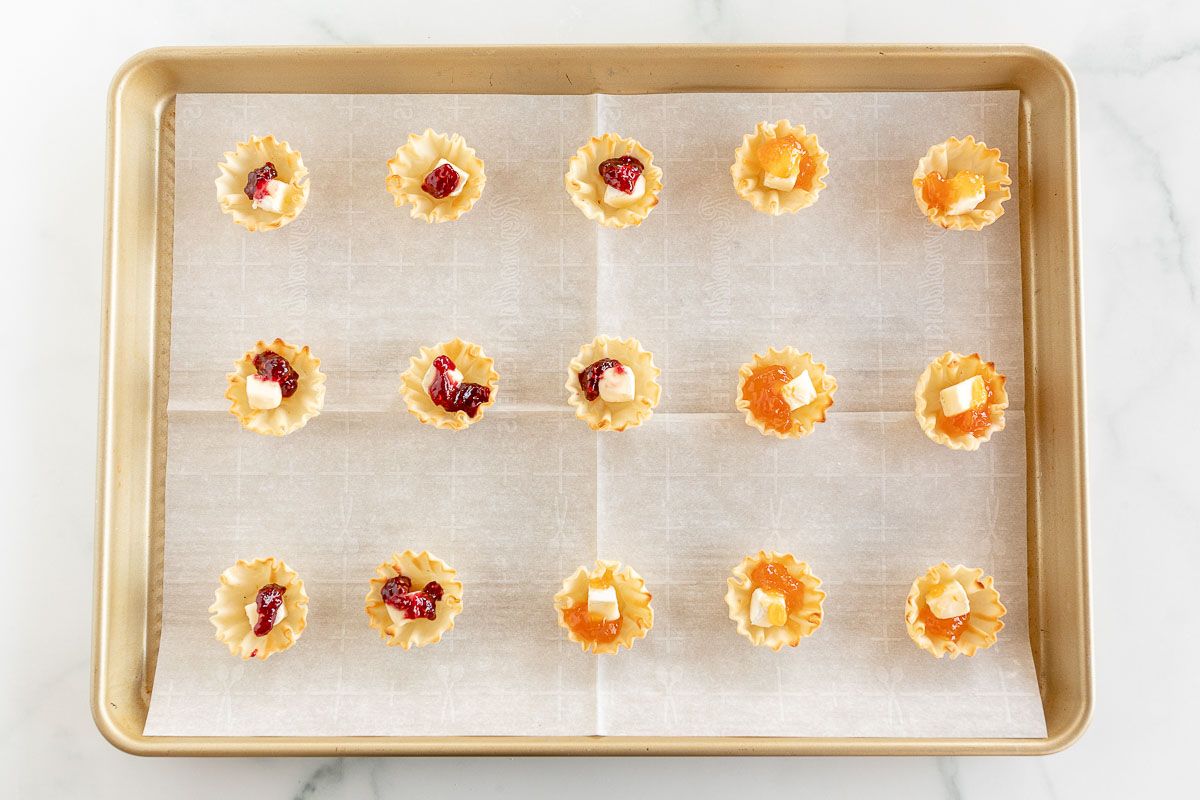 Brie bites on a gold baking pan