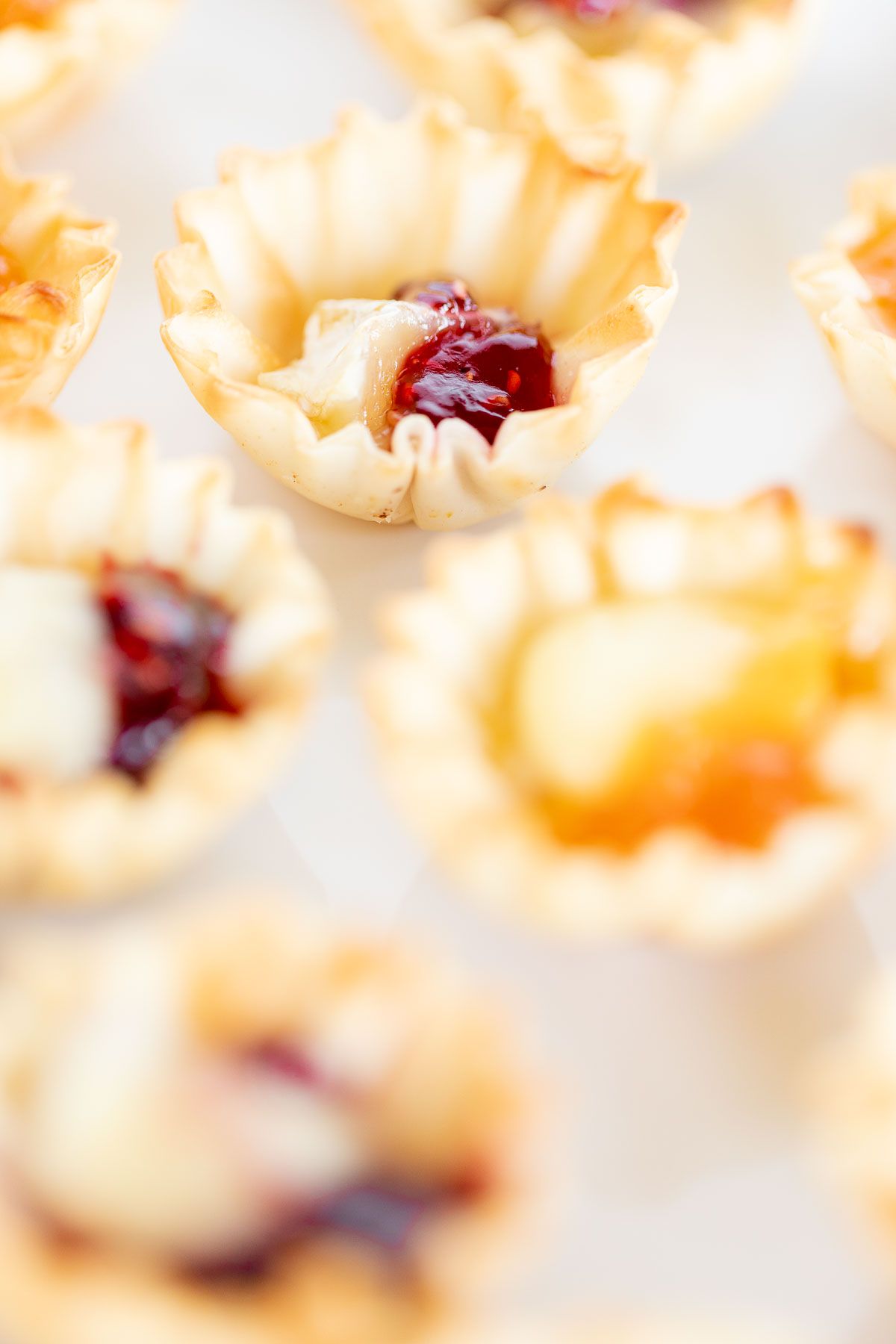 brie bites in puff pastry on a white plate