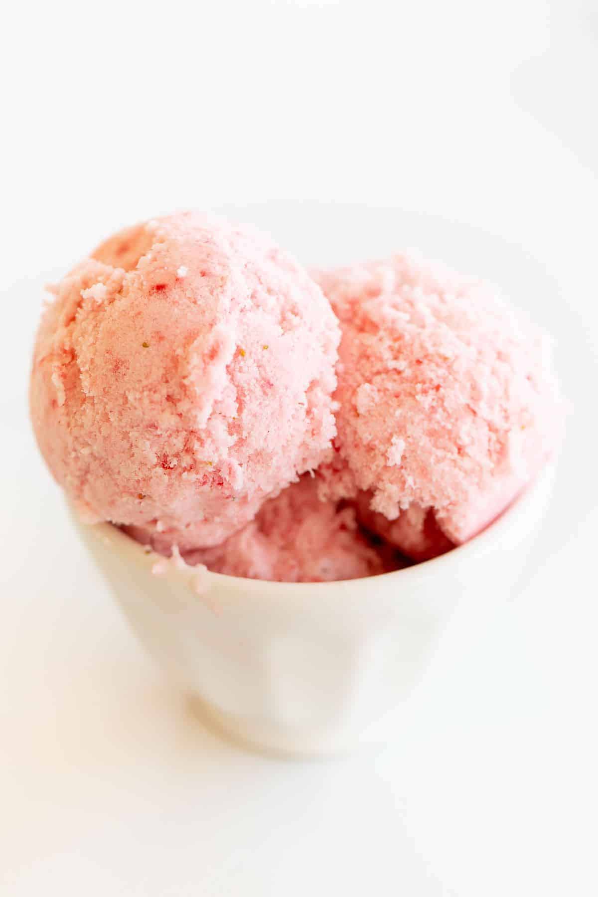 A white bowl of strawberry snow ice cream.