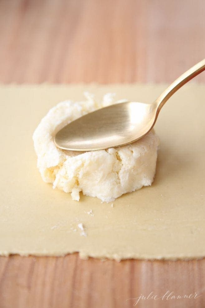 Making a well in the cheese mixture on the pasta sheet