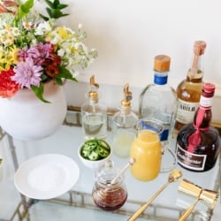 A margarita bar on a gold bar cart
