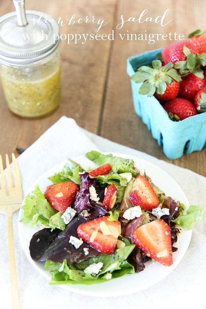Strawberry salad served on a white plate with a text overlay