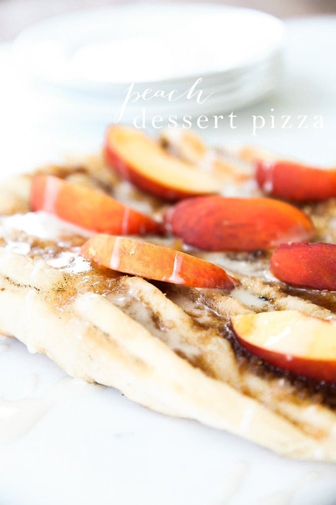 Peach dessert pizza on a white plate