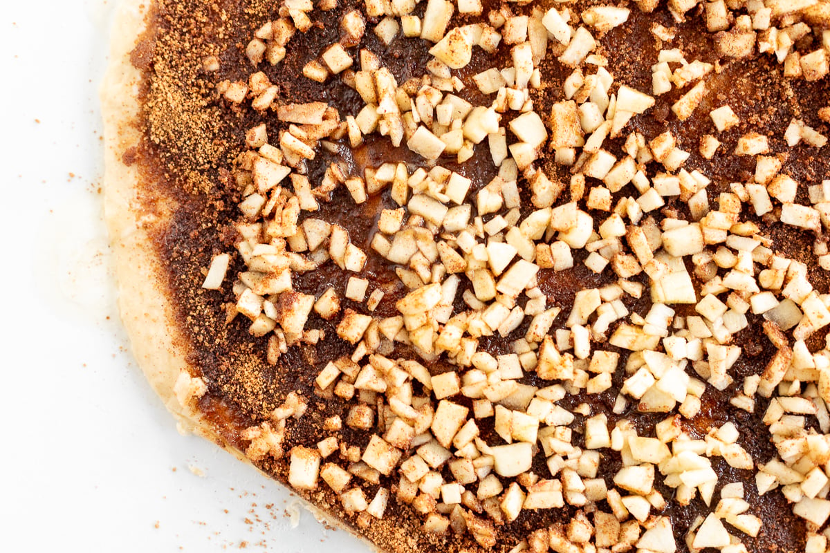 A close up of a pizza with nuts on top.