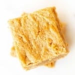 Stack of peanut butter brownies on a white surface