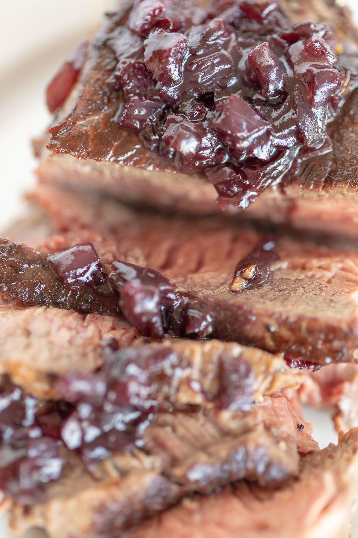 A sliced steak drizzled with red wine sauce for steak.