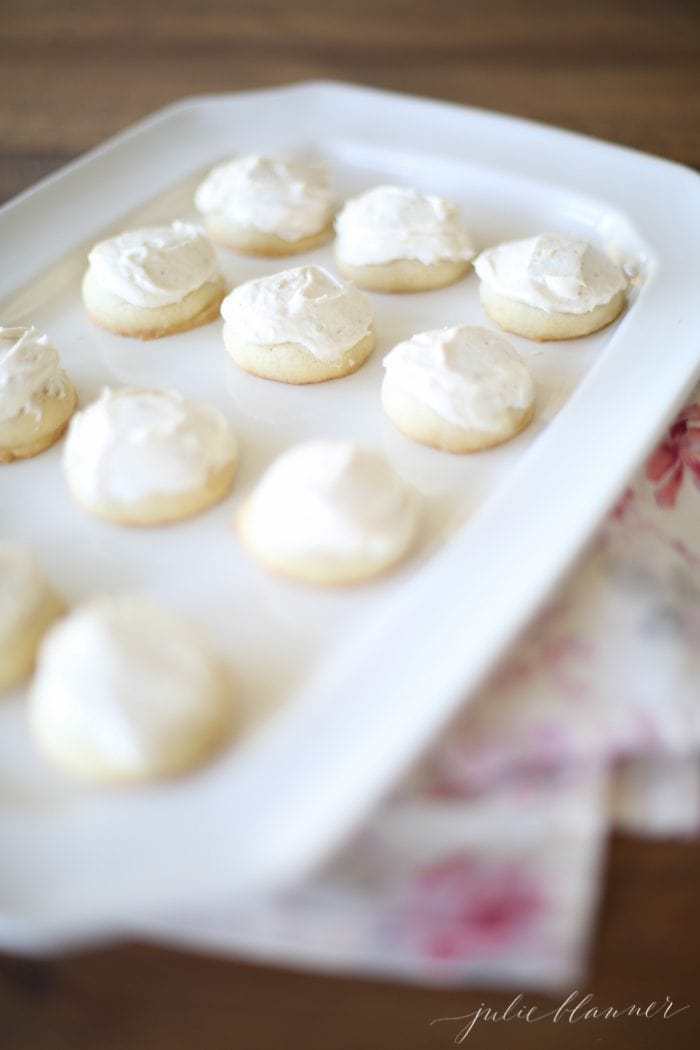 brown butter sugar cookies with brown butter frosting on a white serving plate