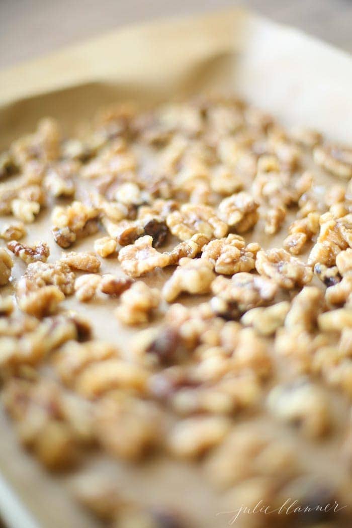 Candied nuts on a baking tray lined with parchment