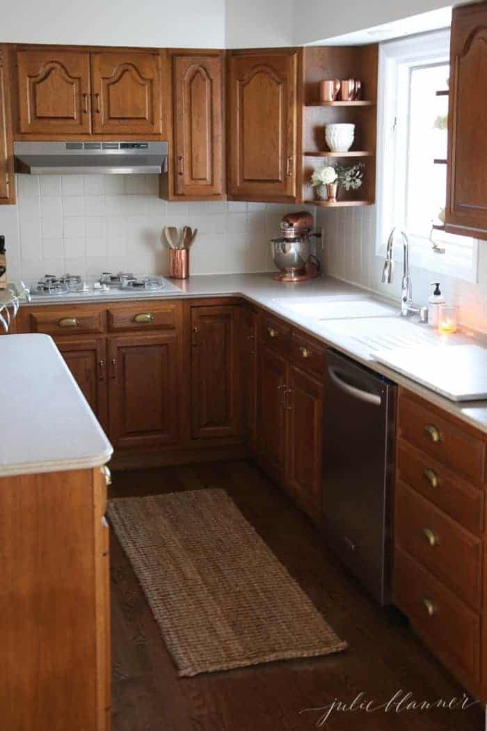 An oak kitchen updated with white kitchen paint colors with oak cabinets.