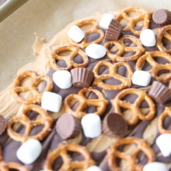 peanut butter bark on a parchment lined baking sheet