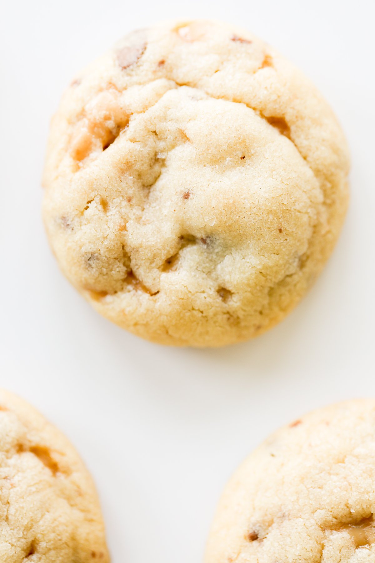 A group of toffee cookies on a white surface.