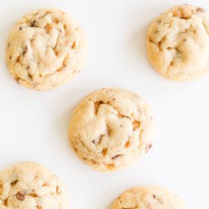 A group of toffee cookies on a white surface.