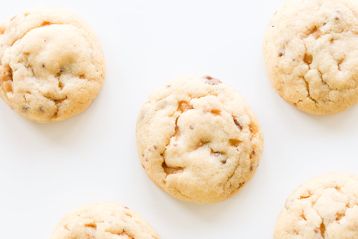 A group of toffee cookies on a white surface.