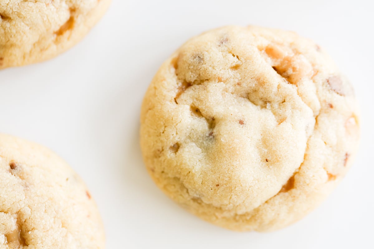 A group of toffee cookies on a white surface.