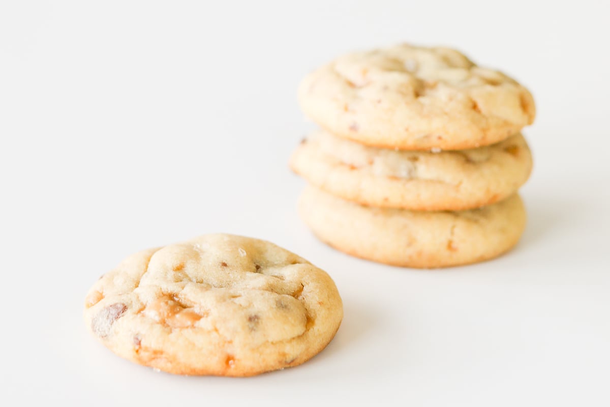 A stack of toffee cookies on a white surface.