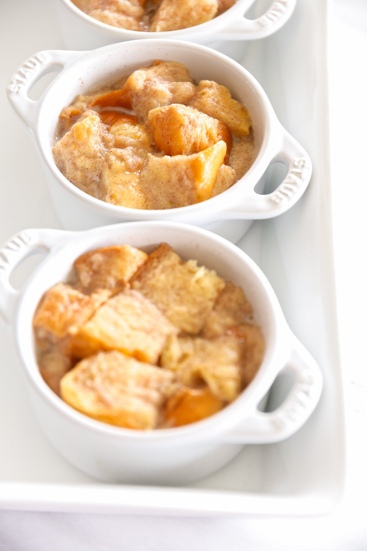 bread pudding in an individual, white baking dish