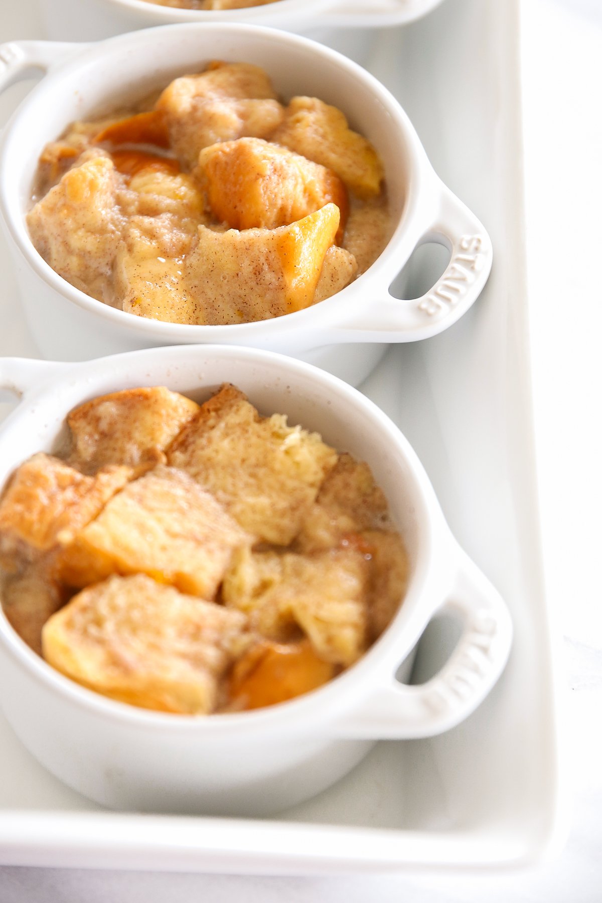 bread pudding in an individual, white baking dish