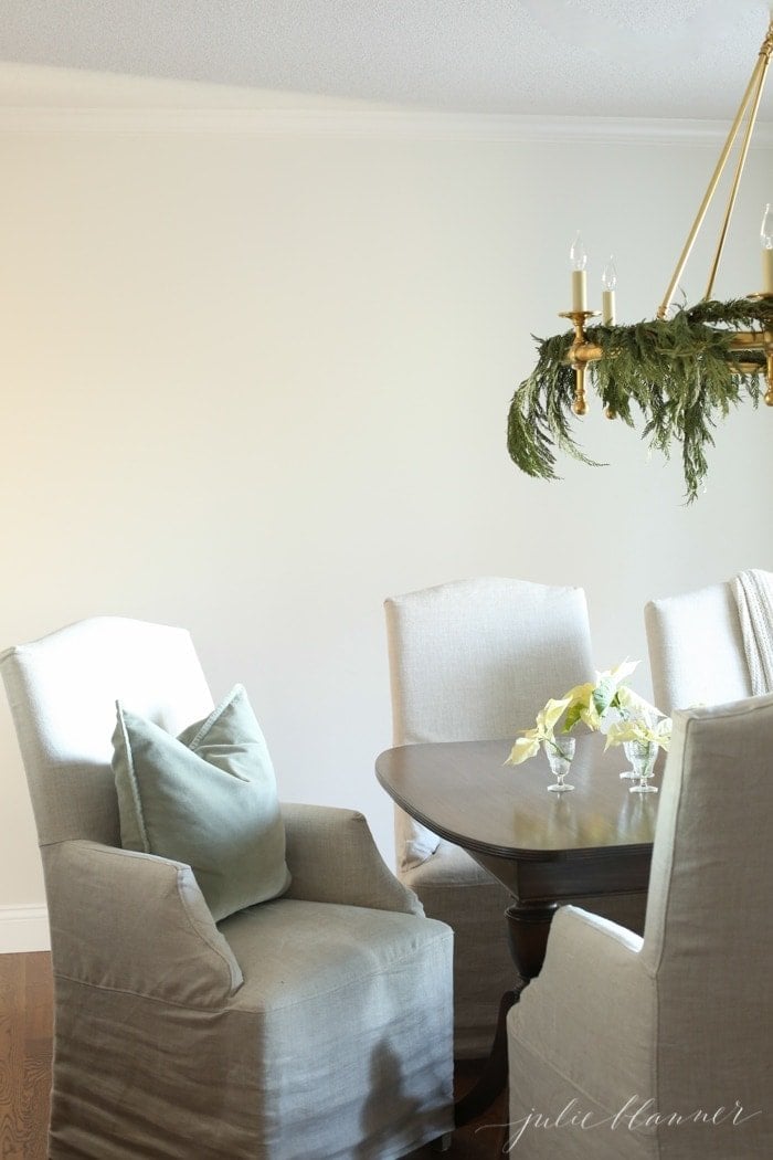 A dark dining table with Restoration Hardware Belgian linen dining chairs.