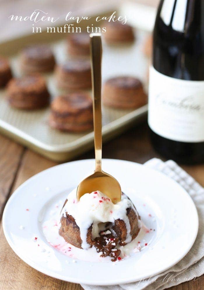 A molten lava cake on a white plate with a gold spoon