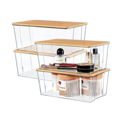 A set of clear storage boxes with cosmetics in a linen closet.