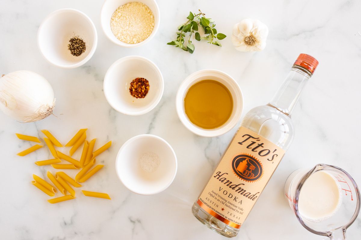 Ingredients for penne alla vodka on a marble countertop