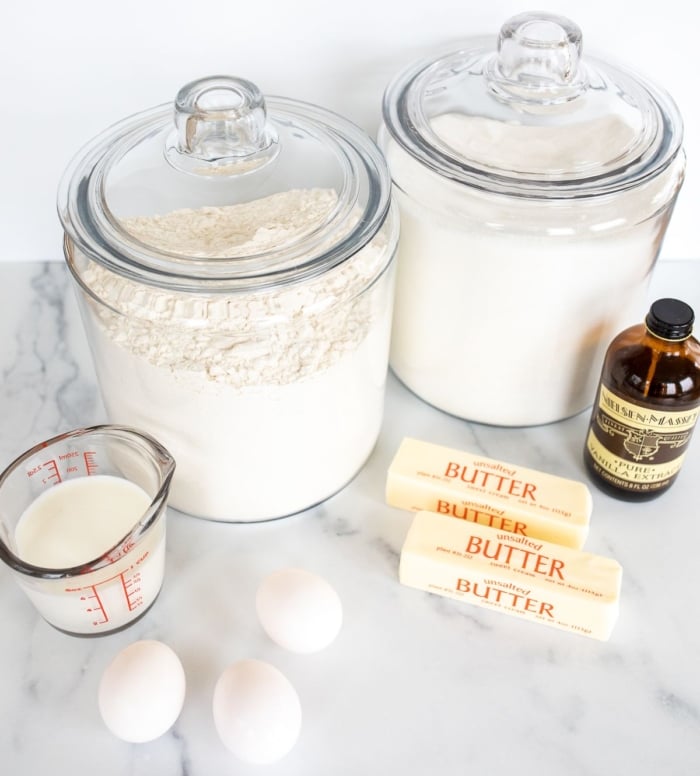 Ingredients for an easy pound cake recipe on a marble countertop.