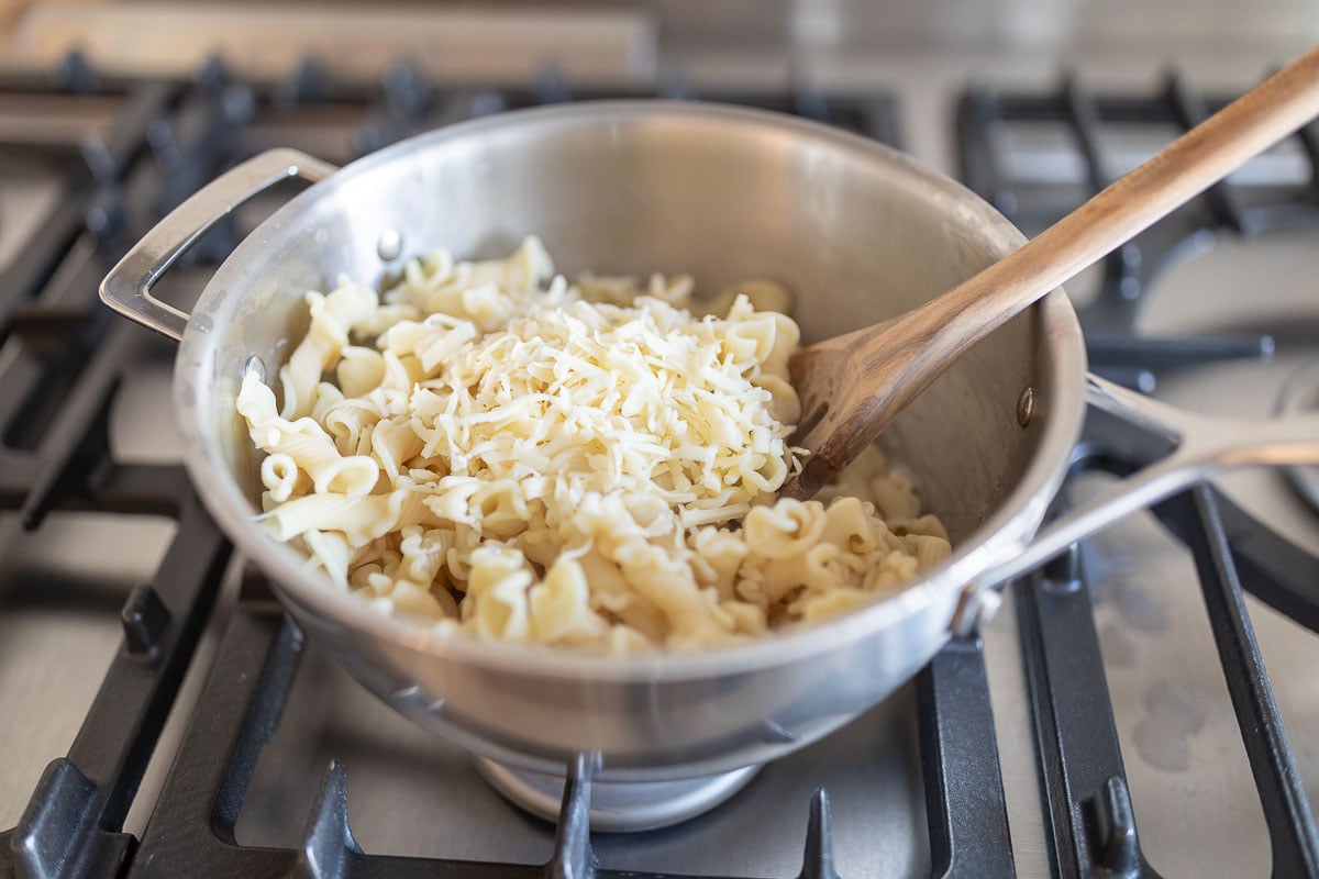 pot of pasta with shredded cheese on top