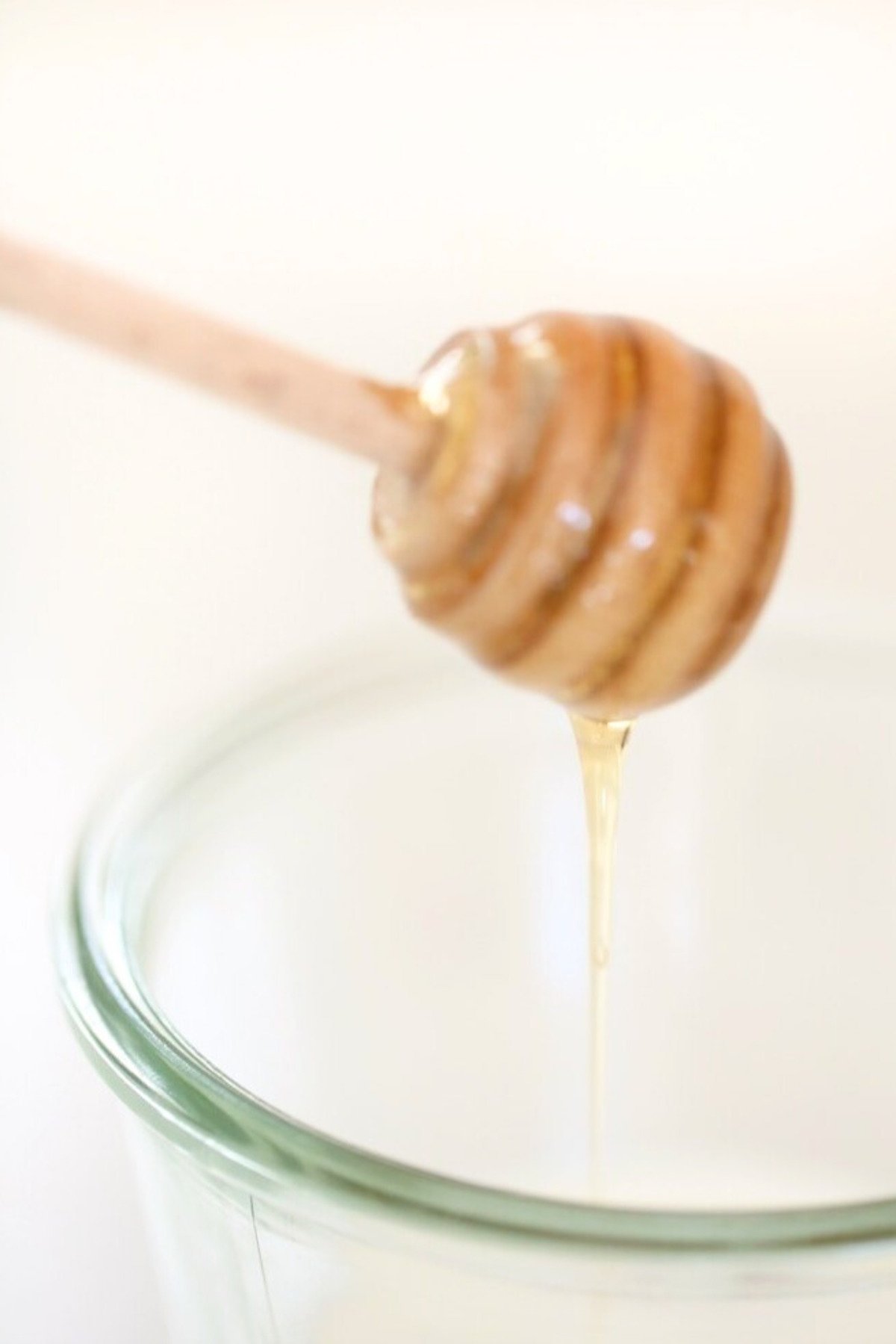 A milk and honey face mask in a small glass jar