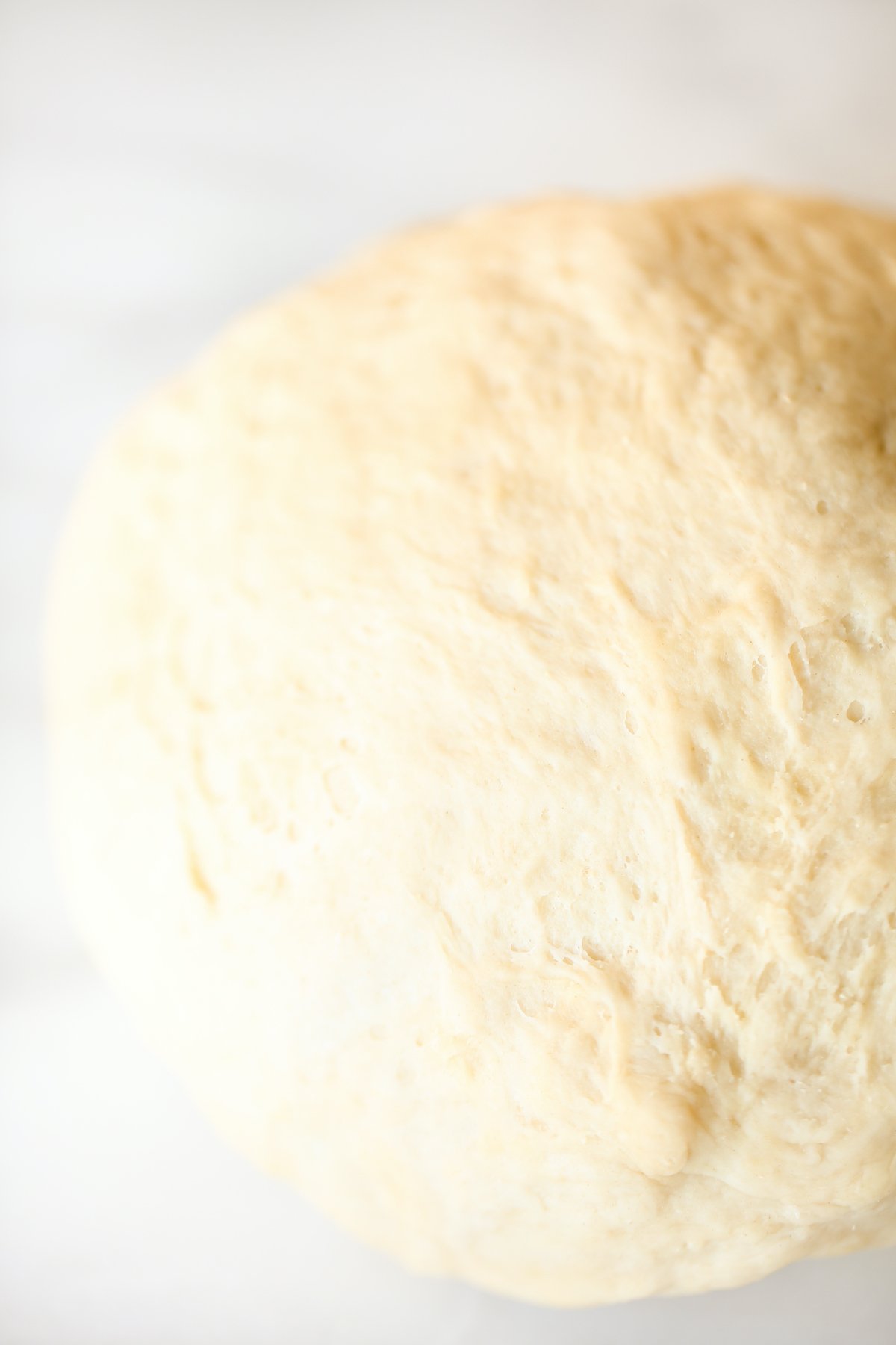 A ball of dough on a marble surface