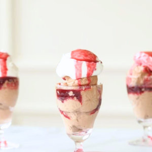 An easy trio of desserts in glasses with chocolate mousse, whipped cream, and raspberry sauce.