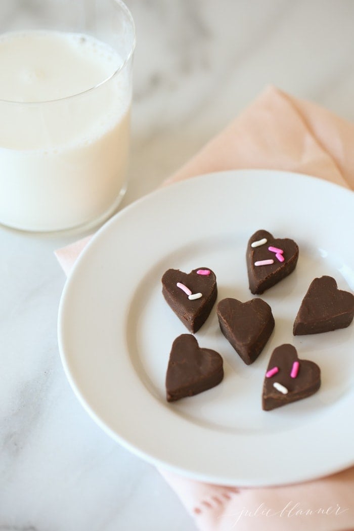 Traditional chocolate fudge cut into hearts on a white plate