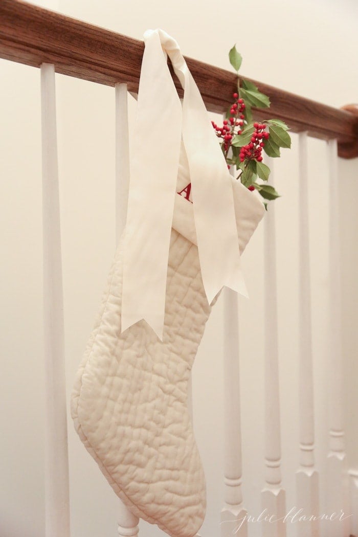 festive Christmas decorations | ivory stockings filled with holly