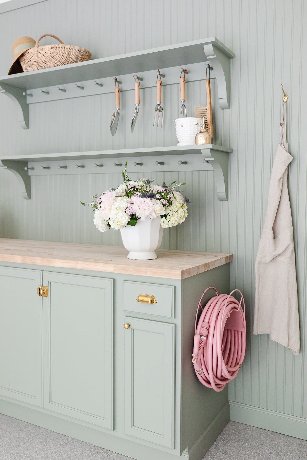 A green garden bench in a garage organization guide.