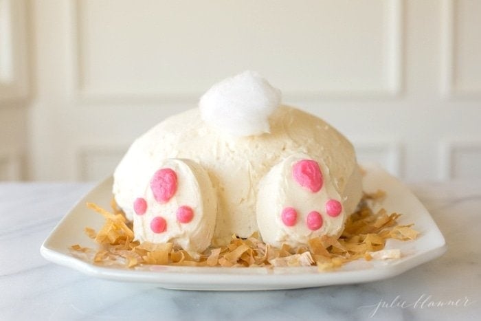 An Easter bunny cake idea of a bunny butt cake on a platter, in a white kitchen.