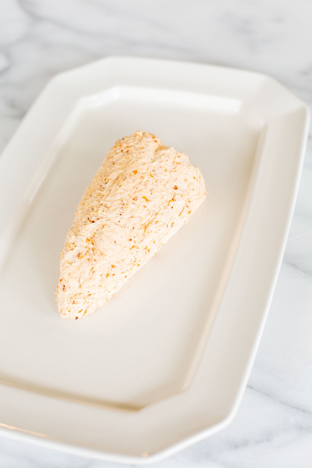 cream cheese formed into a carrot shaped cheese ball.