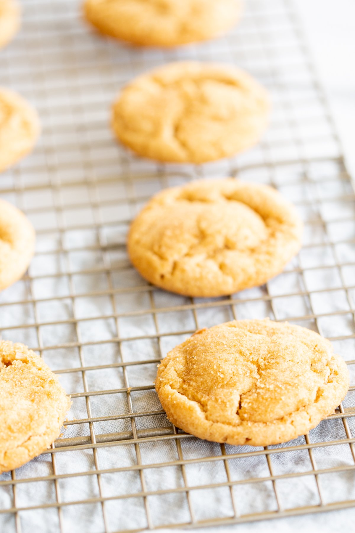 A cooling rack with chocolate stuffed peanut butter cookies.