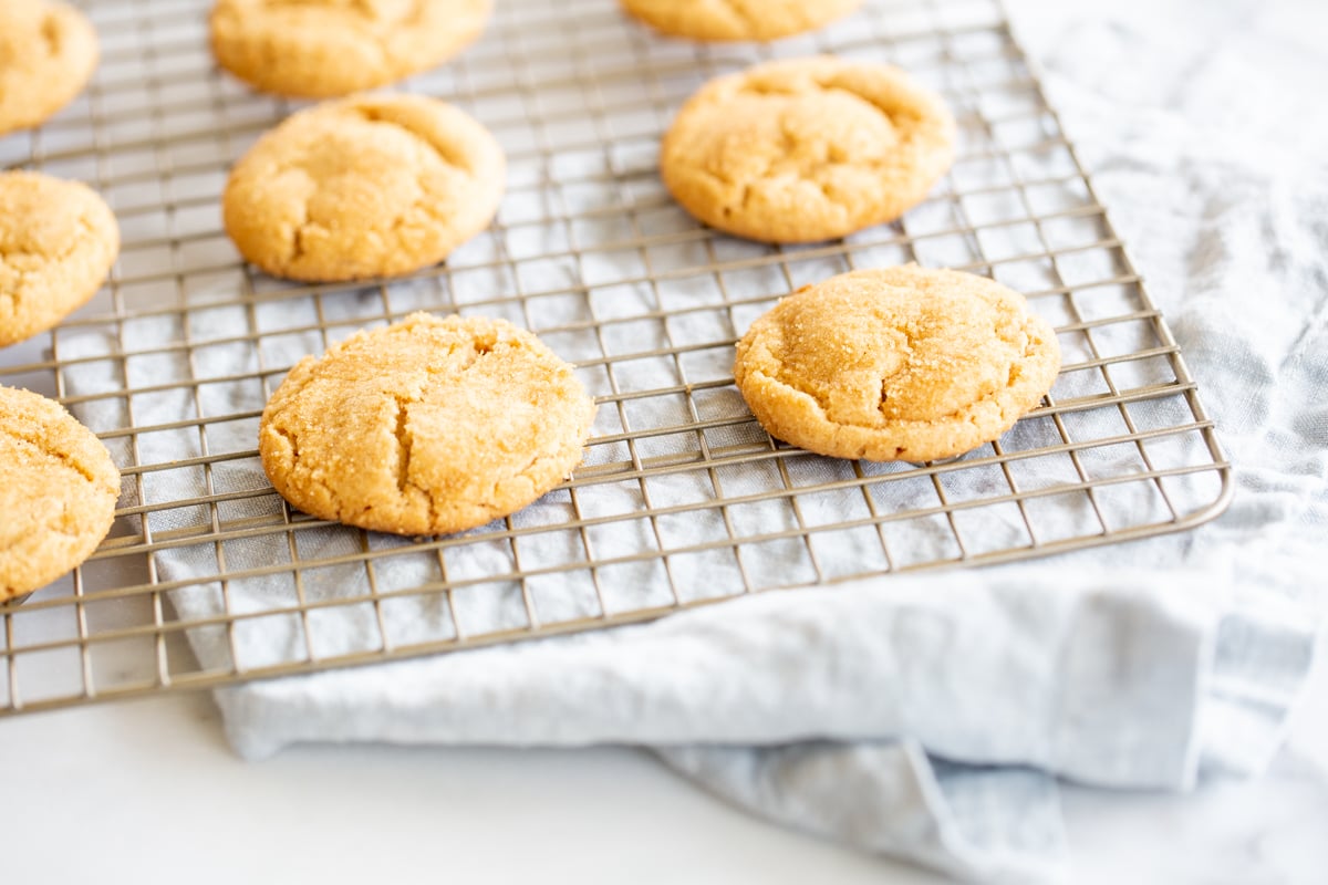 A cooling rack with chocolate stuffed peanut butter cookies.