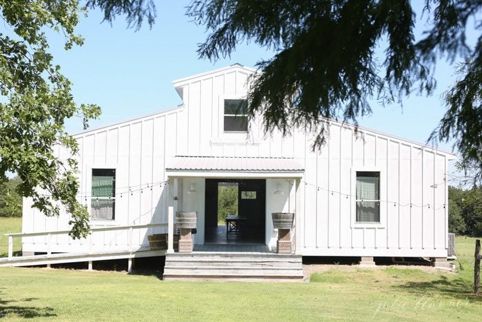 farmhouse exterior - white board and batten barn with metal roof