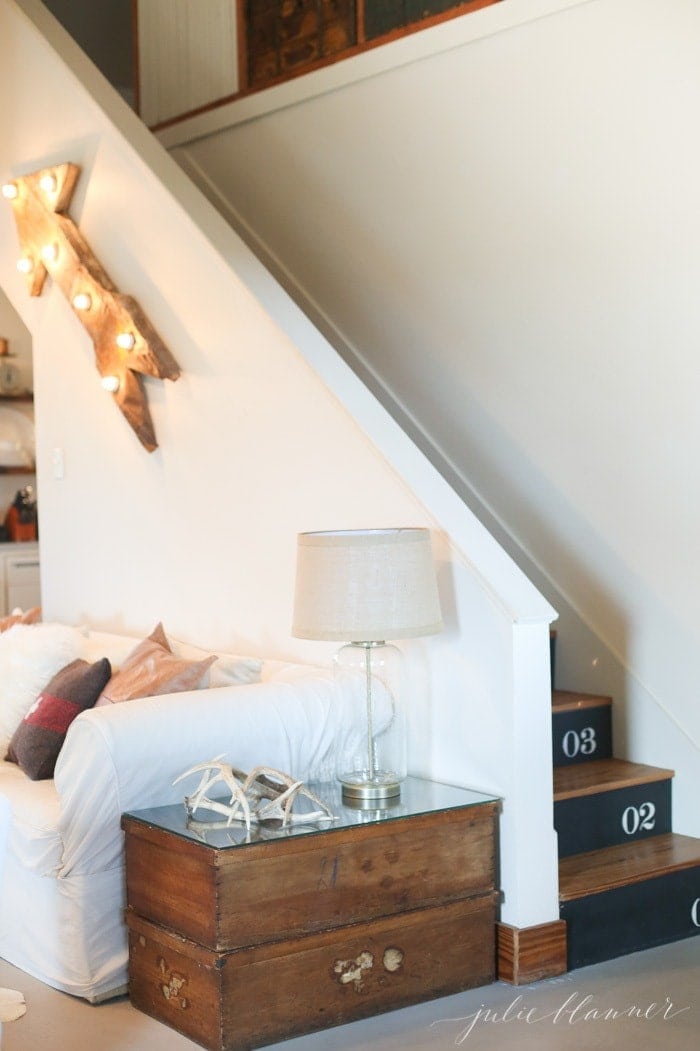 Farmhouse with white walls and a staircase in the living room.