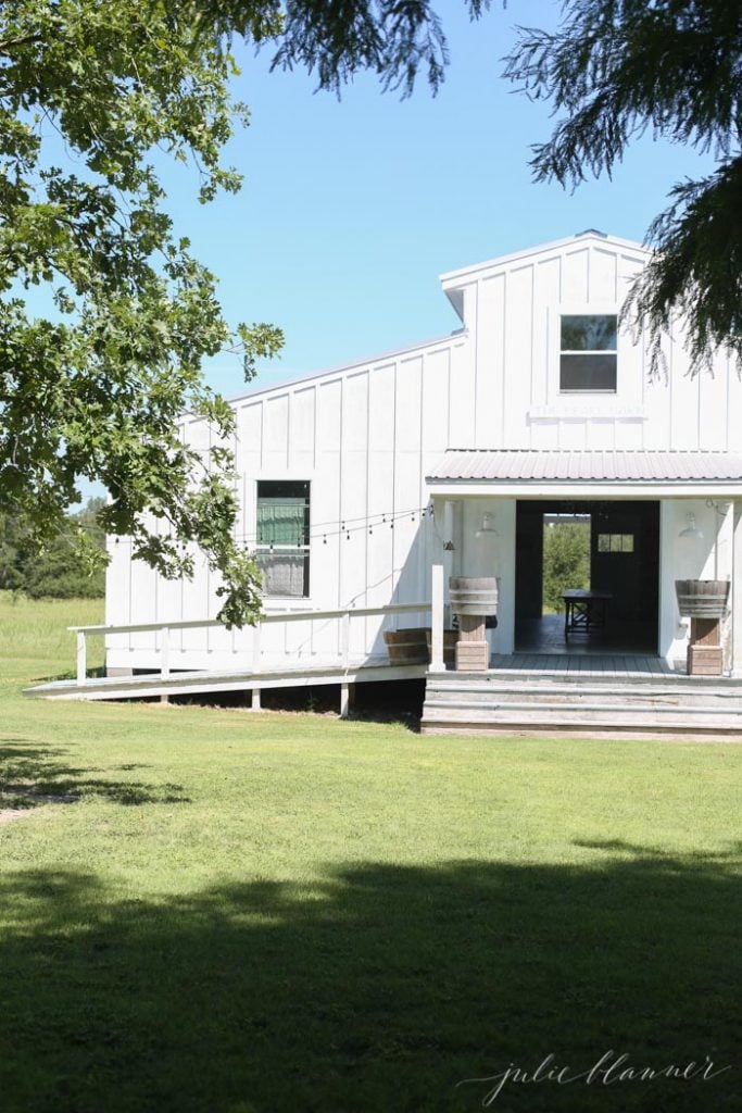 farmhouse exterior - white board and batten barn with metal roof