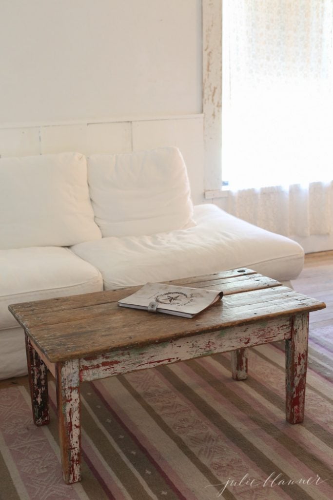 white slipcovered sofa with reclaimed wood coffee table