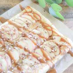 A caramel apple tart, topped with caramel and chopped nuts